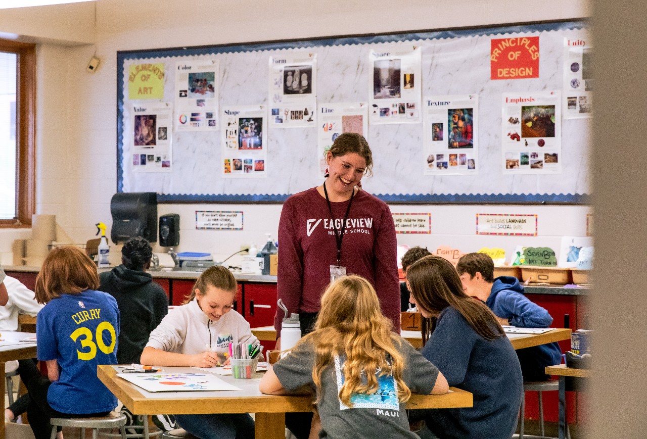 A teacher interacts with her students in class.